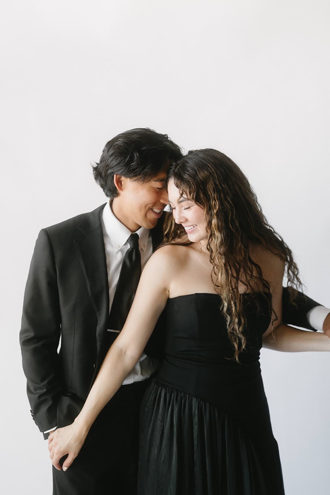 Couple sharing a joyful laugh during their photo booth session